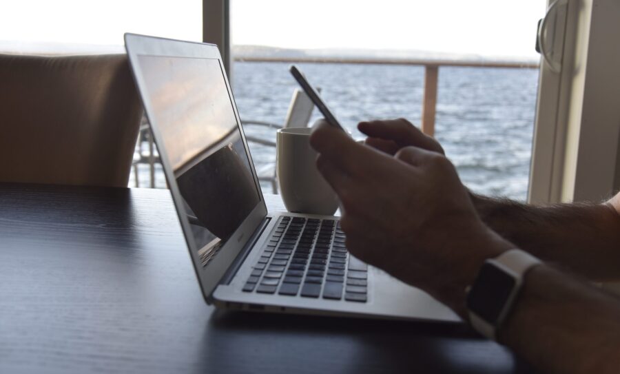 using-cell-phone-and-laptop-computers-2QX26XU